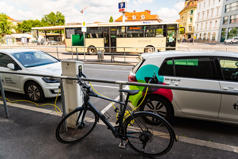 Graz, Austria - 24.06.2020: Modern electric cars EV Car plugged into charging station. New energy vehicles, eco-friendly alternative energy for cars
